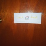 door, doorknob, sign on door, reading sign