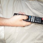 tv remote, remote control, hand holding remote, no tv in bed