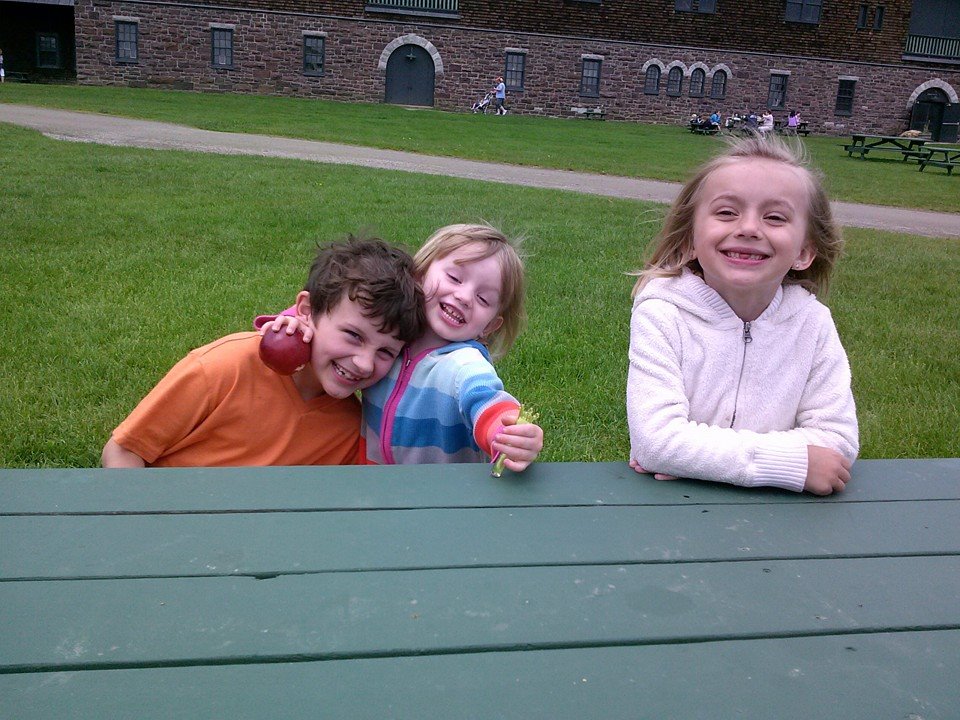 On Being “Done” boy, two girls, brother, two sisters, brother and two sisters, girl holding apple, kids sitting at picnic table, happy siblings