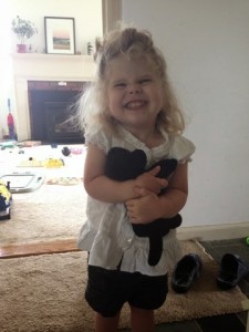 little girl, little girl holding stuffed animal, stuffed animal, black lab toy, little girl holding dog, dog toy
