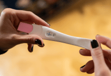 I Can’t Be Pregnant, I Had My Tubes Tied! This is the featured image for a blog post about getting pregnant after having your tubes tied. It shows a positive pregnancy test.