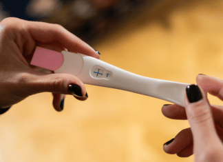 I Can’t Be Pregnant, I Had My Tubes Tied! This is the featured image for a blog post about getting pregnant after having your tubes tied. It shows a positive pregnancy test.