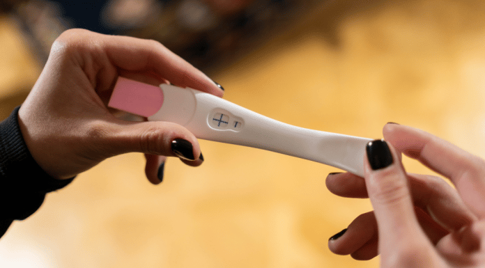 I Can’t Be Pregnant, I Had My Tubes Tied! This is the featured image for a blog post about getting pregnant after having your tubes tied. It shows a positive pregnancy test.
