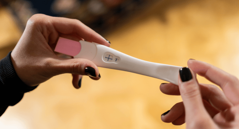 This is the featured image for a blog post about getting pregnant after having your tubes tied. It shows a positive pregnancy test.