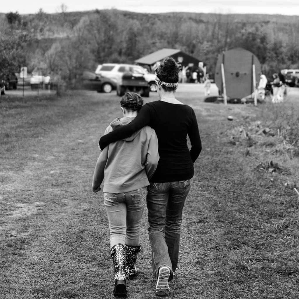 Mother and daughter walking together outside
