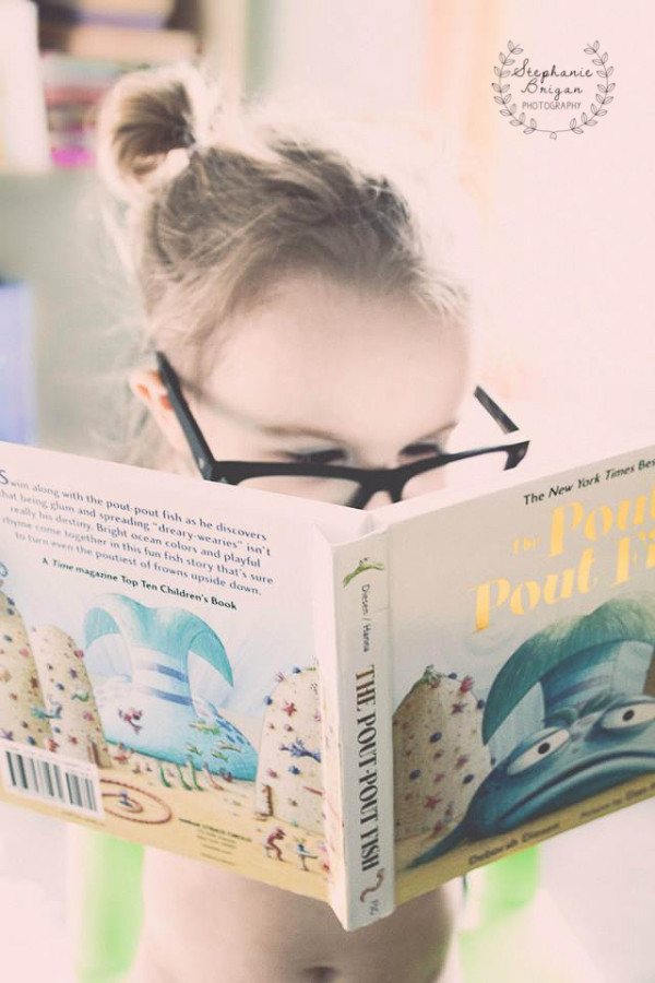 little girl reading, little girl with glasses