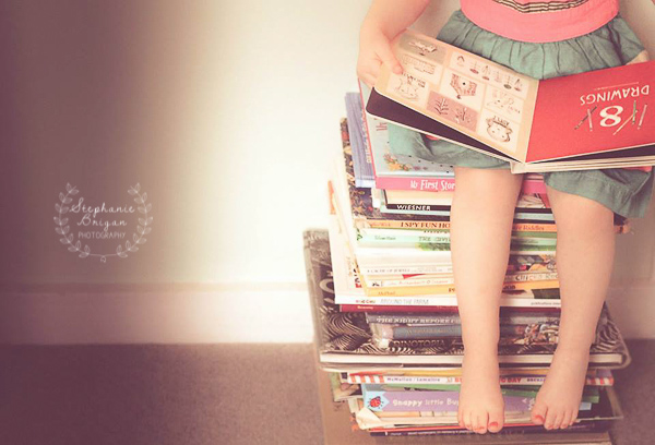 The Joy of Reading stack of books, little girl reading