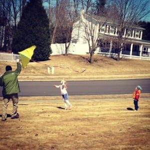 foster kids playing with a flying kite