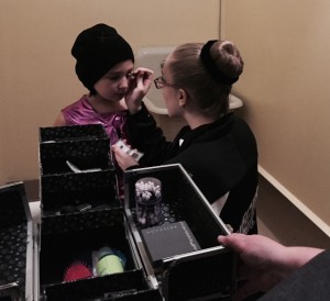 Bun intact. Applying makeup