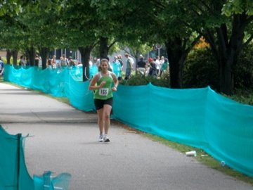 runner, blue fencing, spectators