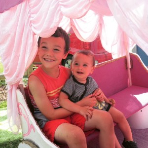two boys, pink carriage, pink seat, frills