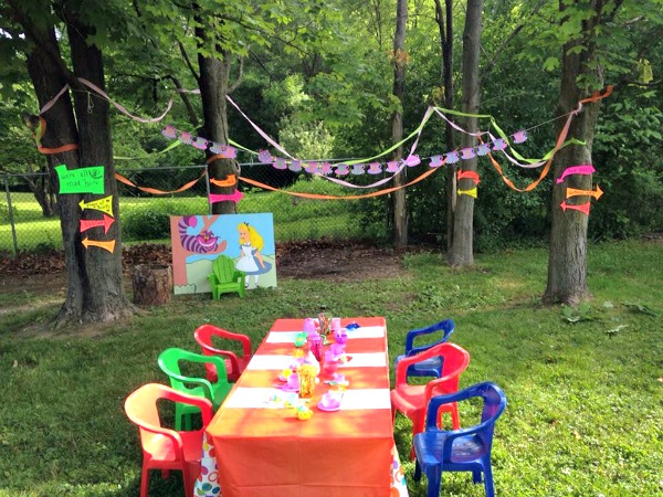 Mad Hatter Tea Party on a Budget! table, chairs, trees, banner, painting