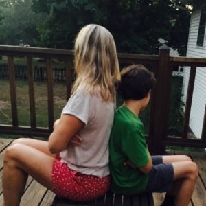 Mom and son sitting back-to-back