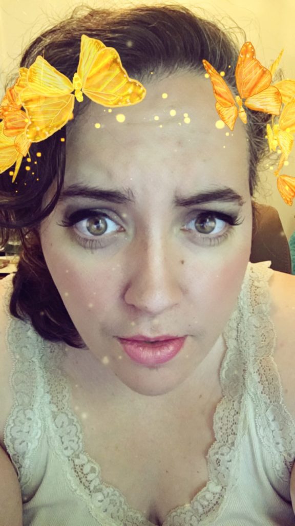 Snapchat filter of golden butterflies.