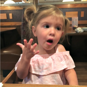toddler sitting at table