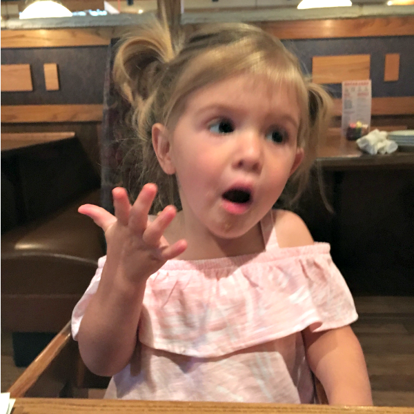 10 Signs I Live With a Toddler toddler sitting at table