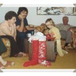 rotating holidays, adults, child, watching, opening presents