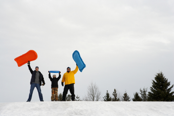 two men and a boy at the summit of one of our favorite Vermont sledding hills