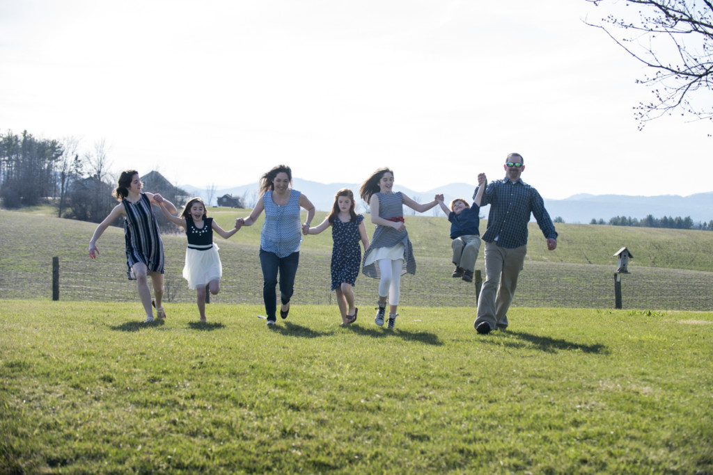 family, field holding hands, no babies