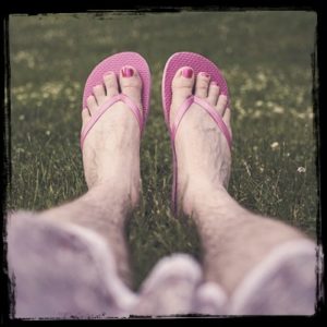 hairy legs in pink flip flops