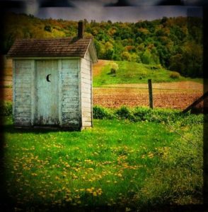 outhouse in a field