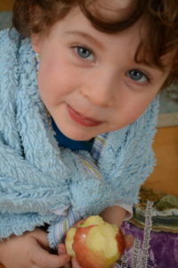 child eating an apple