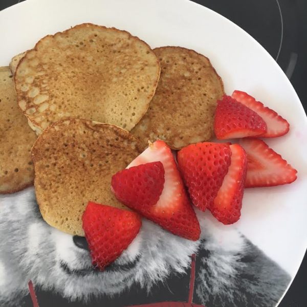 banana pancakes with a side of strawberries