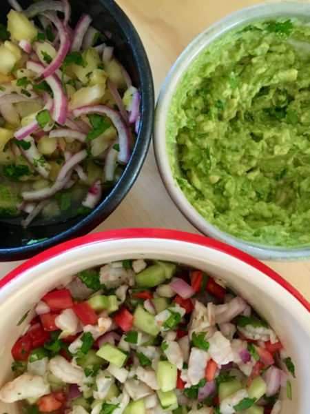 Bowls of shrimp ceviche tostada toppings.