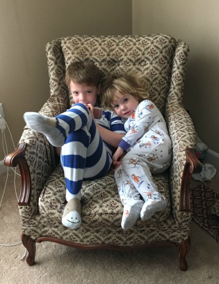 Children in pajamas with a cell phone