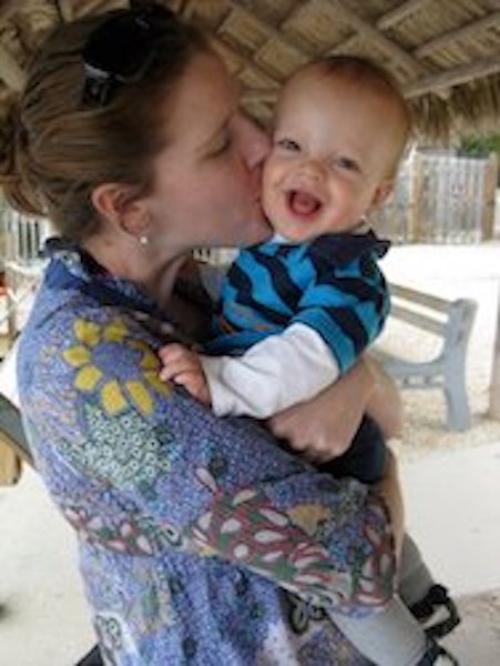 Mom kissing baby while on vacation