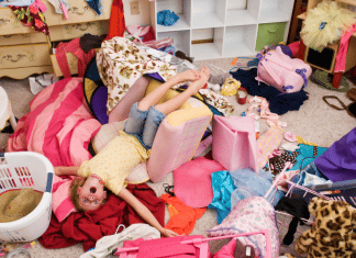 7 Tips to Clean Your Child’s Messy Room without Losing Your Mind messy bedroom with piles of clothing all over