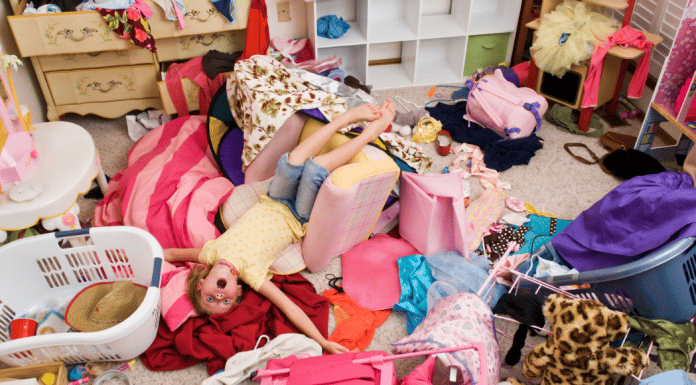 7 Tips to Clean Your Child’s Messy Room without Losing Your Mind messy bedroom with piles of clothing all over
