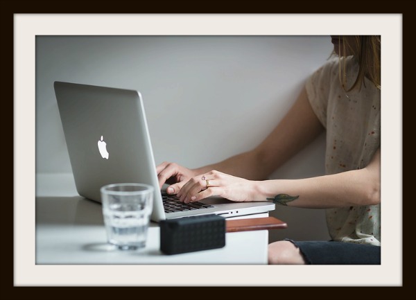 woman typing on laptop
