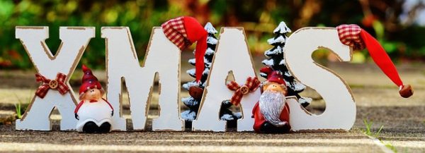 The Holiday Season: Finding Common Ground in Our Marriage Two figures in front of XMAS signt