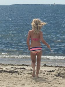 young girl in a bikini at the beach