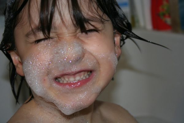 Lifestyle and Habits of the Toddler Mom as Observed in the Wild Close up of child in bubble bath with suds on face