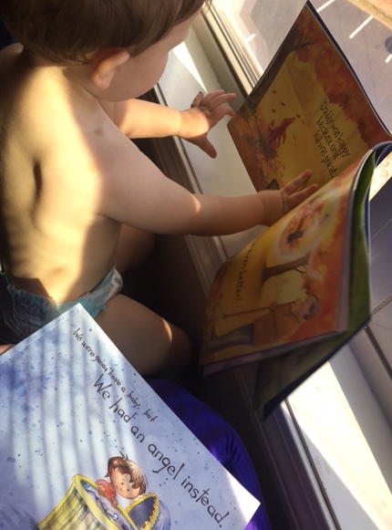 Child reading book about miscarriage.