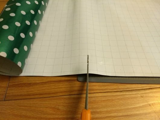 Cutting wrapping paper for the holiday placemats.