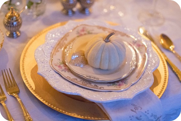 a pumpkin place setting at a table