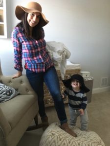 woman in plaid shirt and hat with toddler in hat