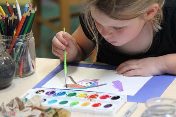 girl painting with watercolors
