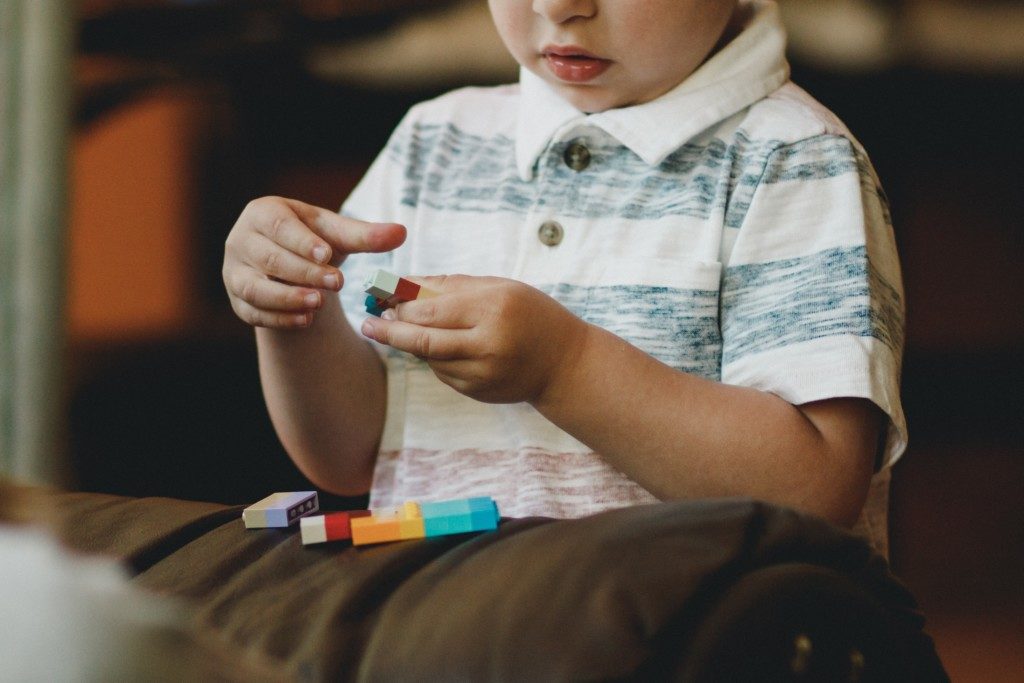 boy playing with legos