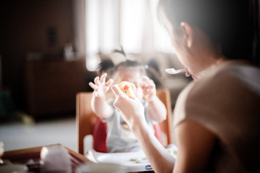 babysitter feeding baby