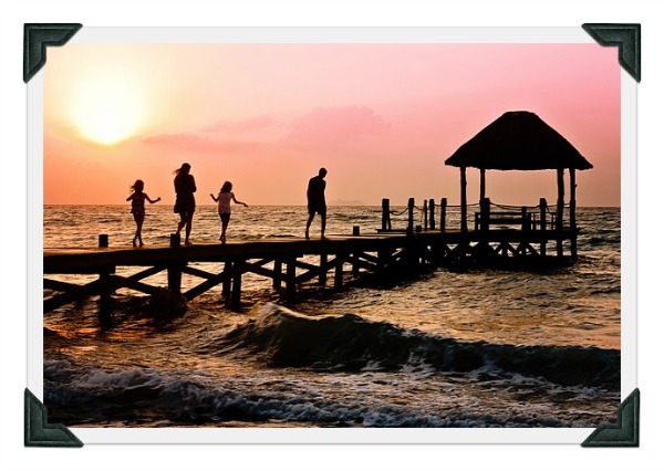 a family on a bridge over water having a perfect time on vacation