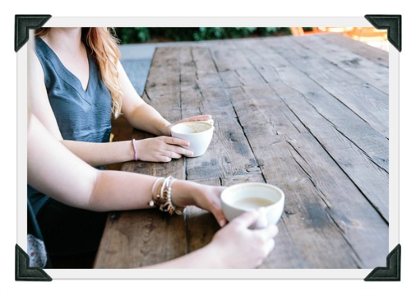 friends drinking coffee at a wooden table