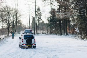 jeep driving away in snow