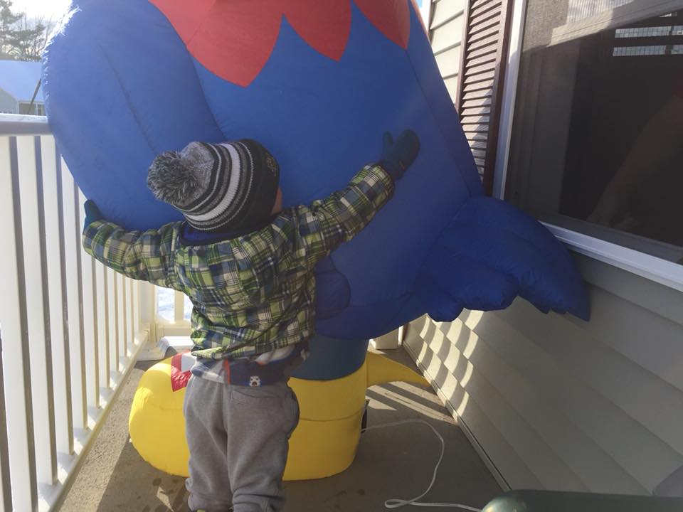 toddler hugs a jayhawker mascot