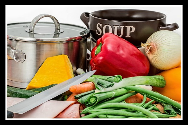 vegetables in front of a soup pot to reduce food waste