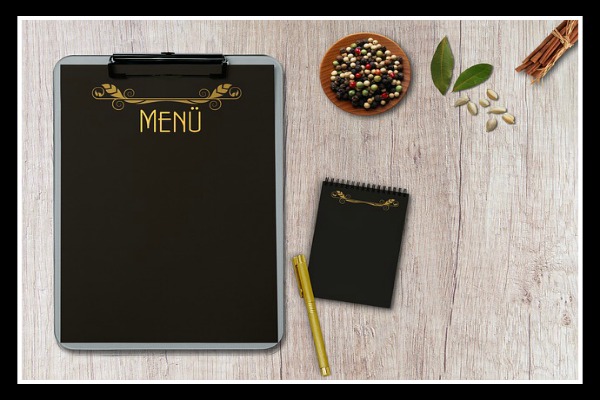 pen and clipboard to plan a menu