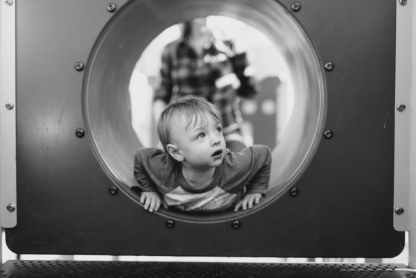 Toddler in play tunnel